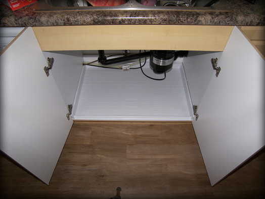 Melamine and cabinet are protected when the Slide N' Fit protector pan is installed